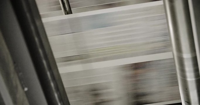 Newspapers move along a conveyor belt at a newspaper factory.