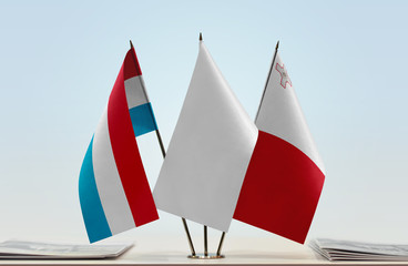 Flags of Luxembourg and Malta with a white flag in the middle