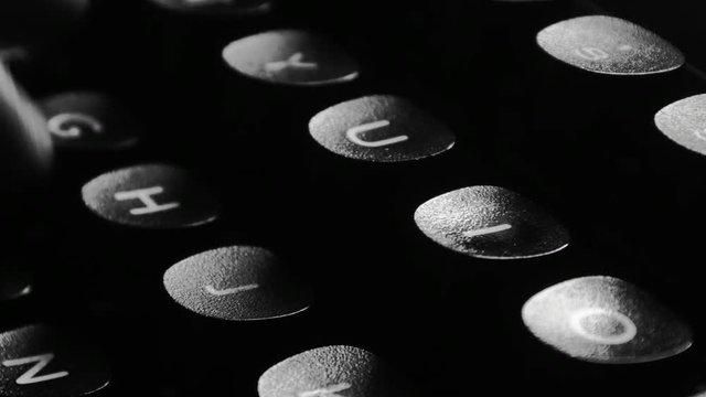Close-up of hands typing on a vintage typewriter machine. Writing a love letter by the window, 4K black and white.