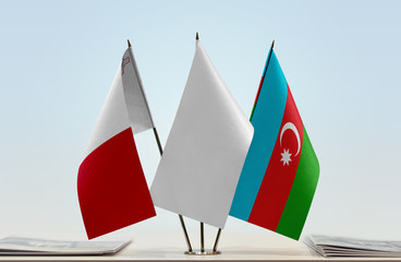 Flags of Malta and Azerbaijan with a white flag in the middle