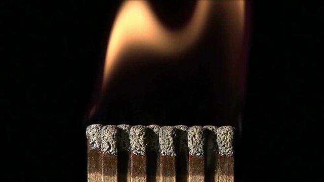A book of matches ignite on fire.