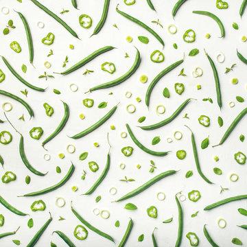 Food pattern, texture and background. Flat-lay of fresh green beans over white wooden background, top view, square crop. Healthy cooking, clean eating, vegan, weight loss, vegetarian, dieting concept
