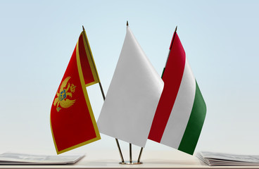 Flags of Montenegro and Hungary with a white flag in the middle