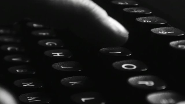 Close-up of hands typing on a vintage typewriter machine. Writing a love letter by the window, 4K black and white.