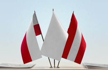 Flags of Poland and Austria with a white flag in the middle