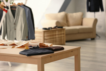 Tailoring tools and fabric on table in atelier
