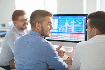Young men working in office