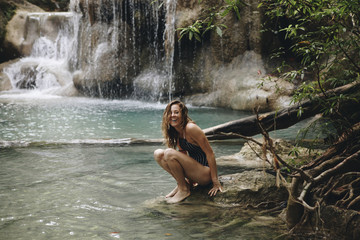 Woman sitting in a natural pond