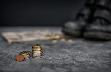 Stacked coins on blurred background. Poverty concept