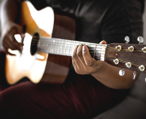Fototapeta premium Man playing an acoustic guitar