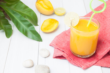 Summer drink, Tropical mango smoothie on wooden white table, Summer holiday concept