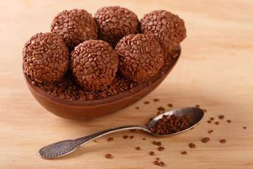 Chocolate egg with filling for Easter on wooden background
