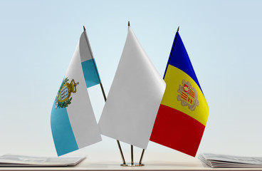 Flags of San Marino and Andorra with a white flag in the middle