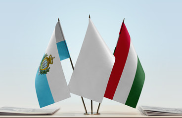 Flags of San Marino and Hungary with a white flag in the middle