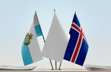 Flags of San Marino and Iceland with a white flag in the middle