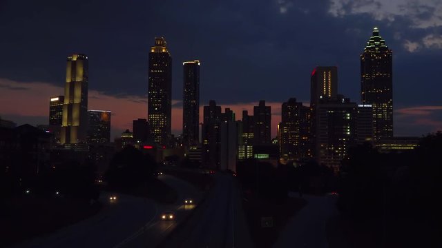 Night falls behind the skyline of Atlanta, Georgia.