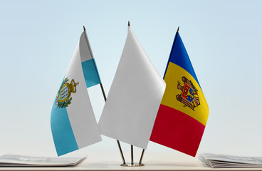 Flags of San Marino and Moldova with a white flag in the middle