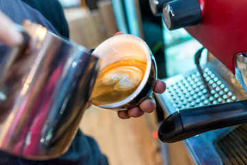 Coffee latte art in coffee shop by barista