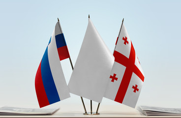 Flags of Slovenia and Georgia with a white flag in the middle