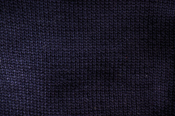 close up of fold dark blue knit sweater fabric texture as background