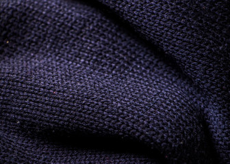 Fototapeta na wymiar Fold dark blue knit sweater, closeup fabric texture as background photo