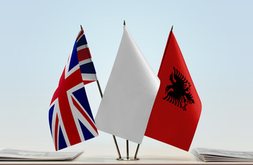 Flags of Great Britain and Albania with a white flag in the middle