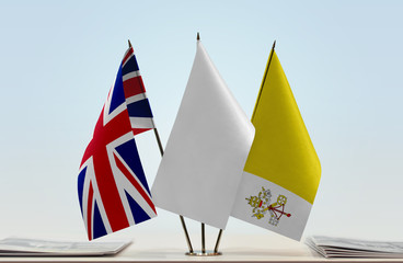 Flags of Great Britain and Vatican City with a white flag in the middle