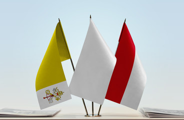 Flags of Vatican City and Monaco with a white flag in the middle