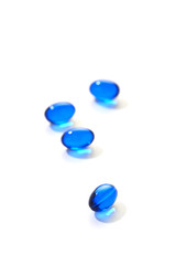 Blue pills capsule on white background