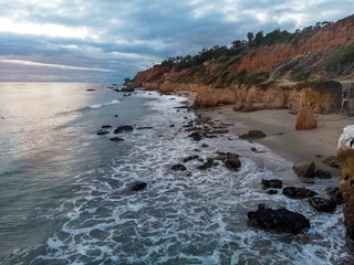 Scenic ocean beach with rocks in Malibu, California.