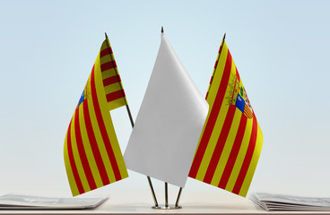 Two flags of Aragon with a white flag in the middle