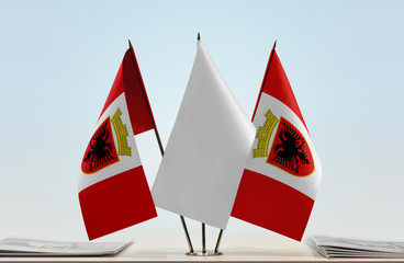 Two flags of Republic of Ilirida with a white flag in the middle