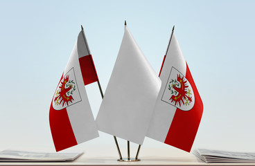 Two flags of Tyrol state with a white flag in the middle