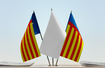 Two flags of Valencia nationalism with a white flag in the middle