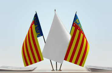 Two flags of Valencia with a white flag in the middle