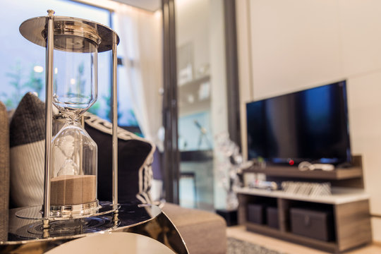 A Hourglass Side Sofa With Television In Livingroom.