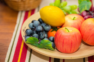 Fruits on dining table apple orange and grape