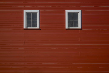 Two windows (that look like eyes) on the side of a red barn in rural Iowa (Midwest, USA) - 196441235