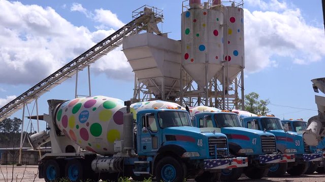 Trucks and cement towers are decorated with polkadots at this artistic business.