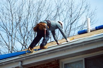 Handyman working on repairing the roof