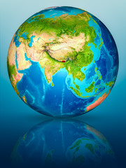 Bhutan on Earth on reflective surface