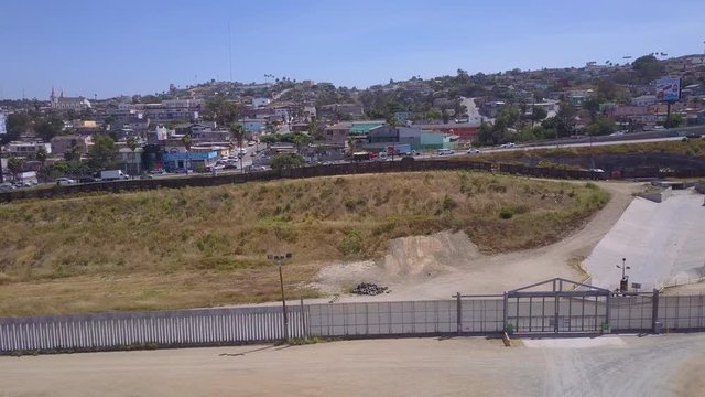 An aerial over the border wall fence separating the US from Mexico and San Diego from Tijuana.