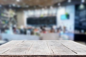 Selected focus empty brown wooden table and Coffee shop or restaurant blur background with bokeh image. for your photomontage or product display.