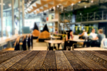 Selected focus empty brown wooden table and Coffee shop or restaurant blur background with bokeh image. for your photomontage or product display.