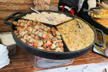 Street fast food -  boiled rice,  beef meat  with vegetables  and fried  smoked pork on wooden skewers