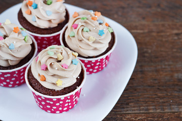 Chocolate cupcakes decorated with cream rose hearts