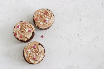 Chocolate cupcakes decorated with cream rose hearts