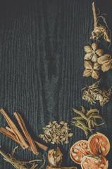 Dried herbs and Ginseng, Top view of Thai herbs and ginseng on wooden floor. Slices of dries root for make a herb juice on the dark table.