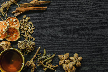 Dried herbs and Ginseng, Top view of Thai herbs and ginseng on wooden floor. Slices of dries root for make a herb juice on the dark table.
