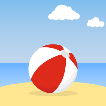 Beach ball lying in the sand. Beach ball against the blue sky.